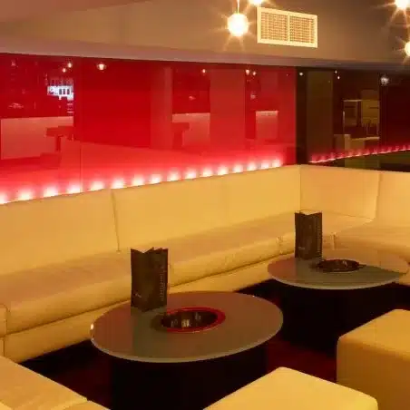 About Us Nightclub with red and black glass on the walls.